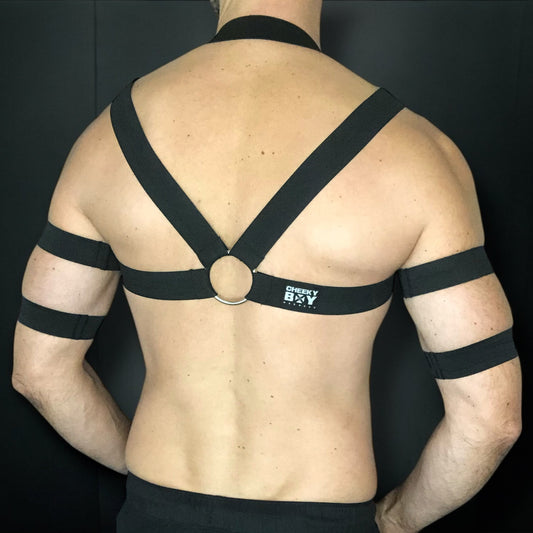 Made-to-measure black men's chest harness with silver chain loops by CheekyBoyHarness. Features stretchy elastic straps, metal rings, and 4 matching armbands. Perfect for pride events, festivals, raves, fetish events and clubwear.