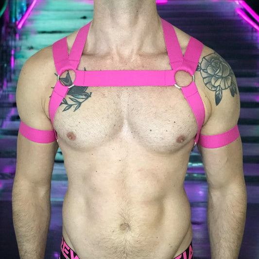 Man Wearing a Made-To-Measure Hot Pink Elastic Body Harness with Metal Rings and Matching Bicep Bands by Cheeky Boy Harness