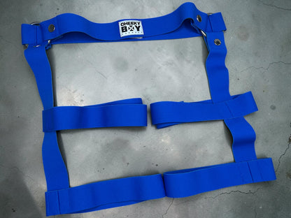 Royal blue elastic harness shorts laid flat to show the complete thigh strap design
