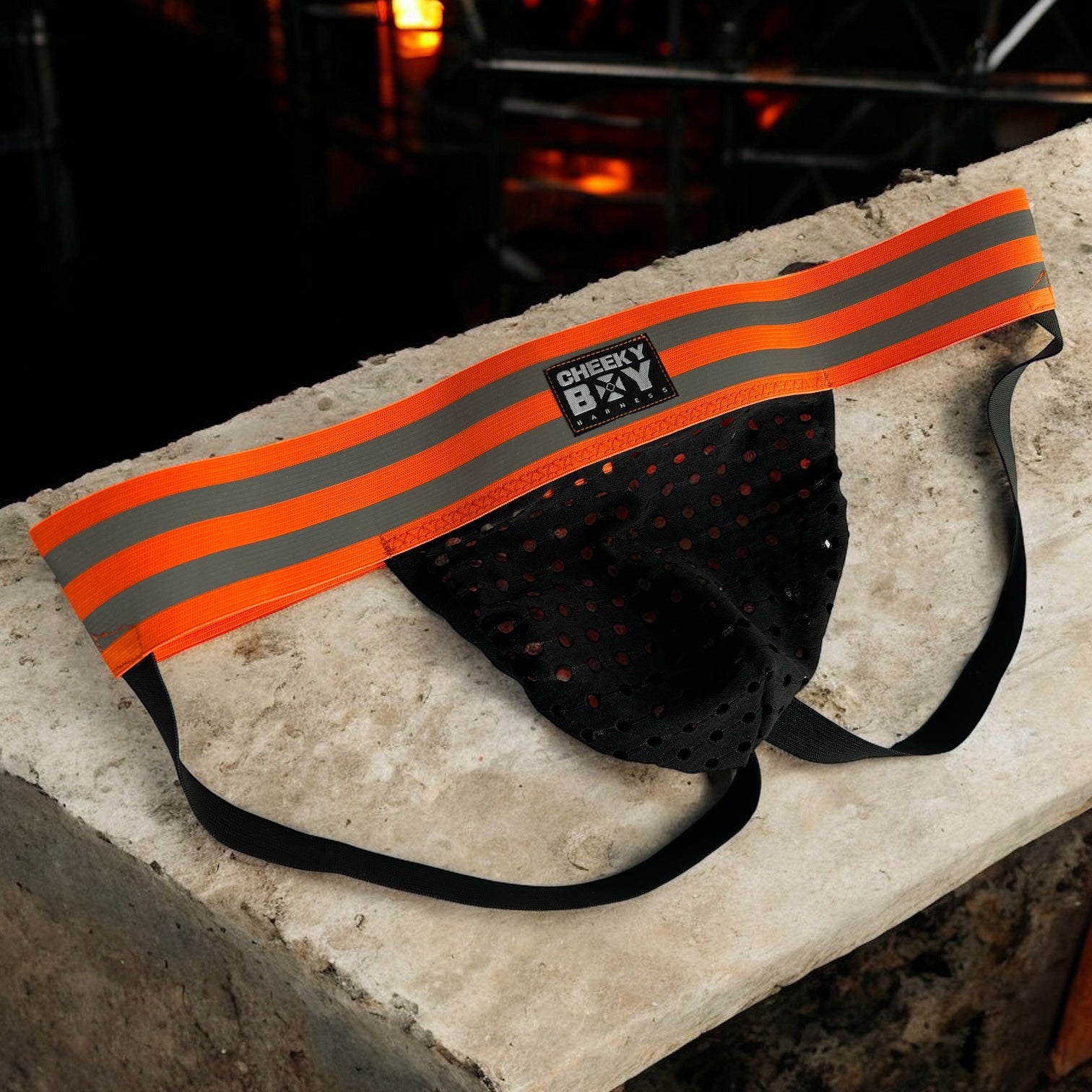 Black mesh pouch jockstrap with a wide hi-vis neon orange reflective waistband, branded Cheeky Boy Harness.