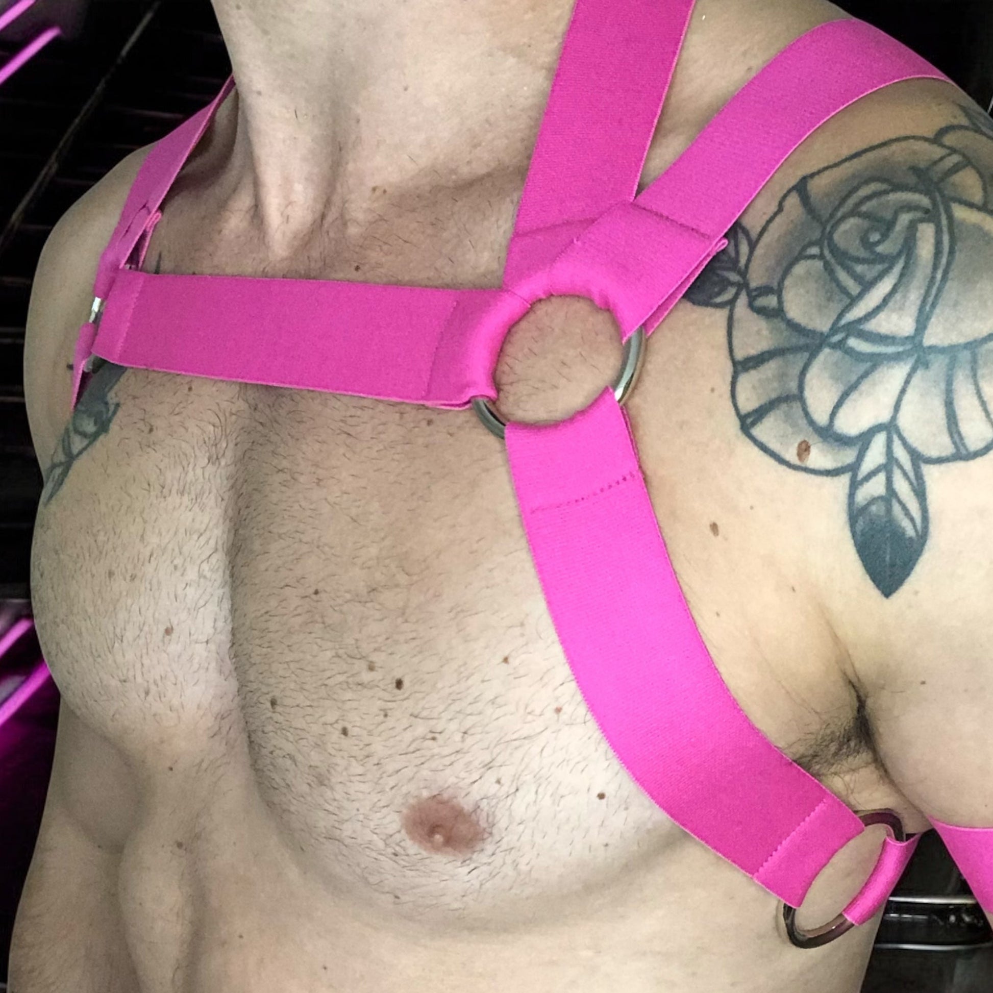 Man Wearing a Made-To-Measure Hot Pink Elastic Body Harness with Metal Rings and Matching Bicep Bands by Cheeky Boy Harness