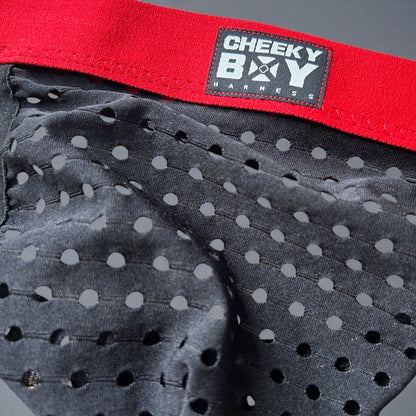 Men’s black mesh Christmas jockstrap with red elastic waistband, featuring a Cheeky Boy Harness black and brand logo at the centre.