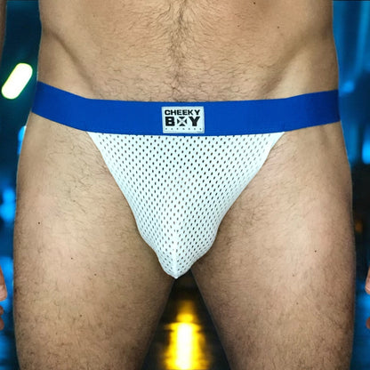 Model wearing a custom hot Royal Blue elastic body harness by Cheeky Boy Harness, featuring a silver chest ring, matching bicep bands, and thigh straps, styled with a pink mesh jockstrap.