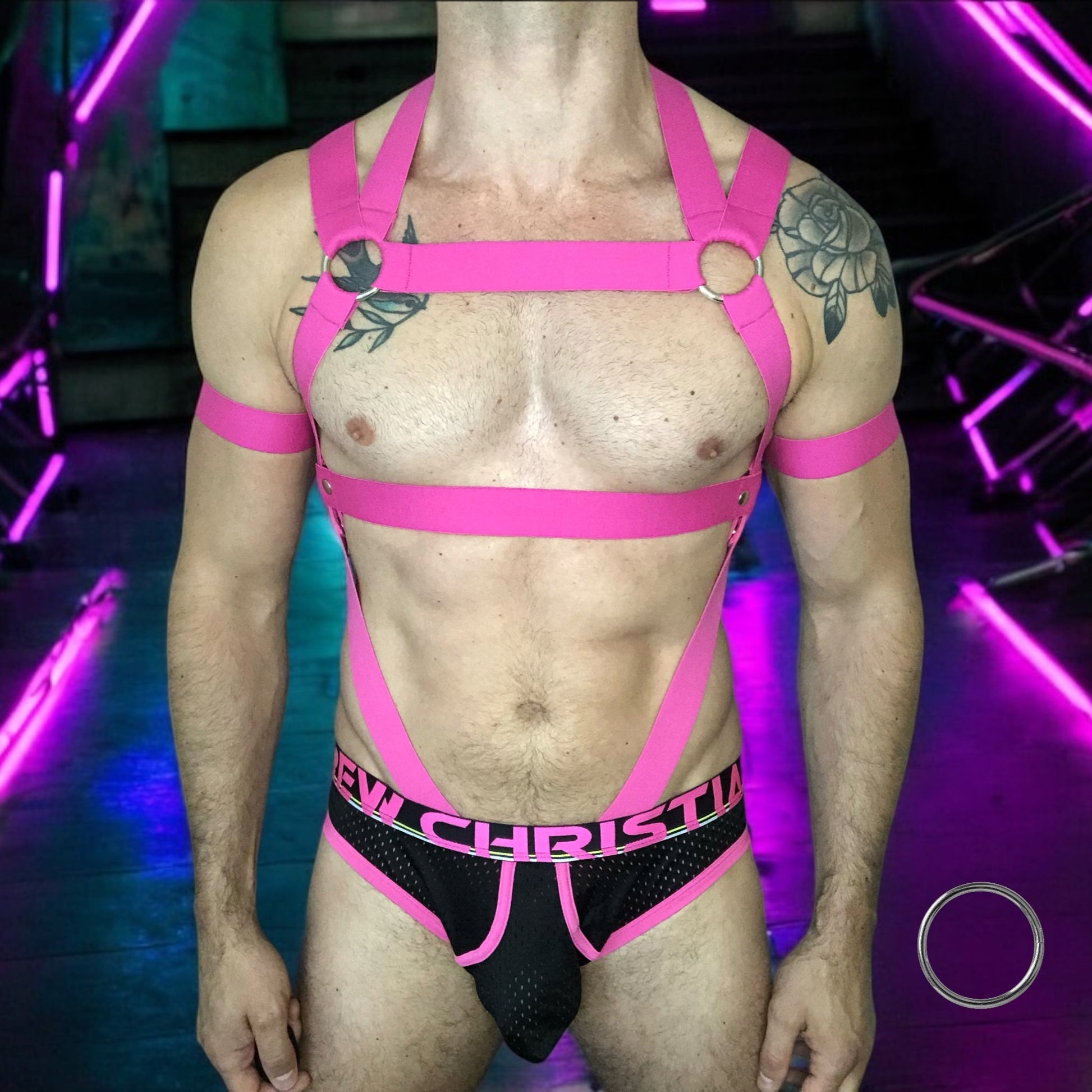 Man Wearing a Made-To-Measure Hot Pink Elastic Body Harness with Metal Rings and Matching Bicep Bands by Cheeky Boy Harness