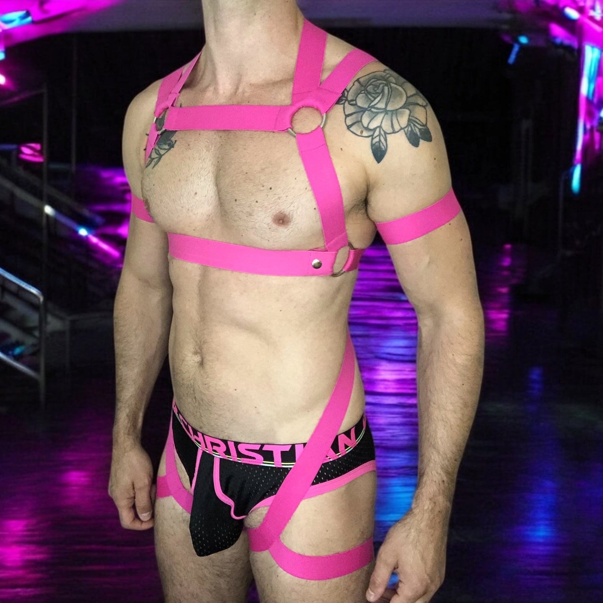 Man Wearing a Made-To-Measure Hot Pink Elastic Body Harness with Metal Rings and Matching Bicep Bands by Cheeky Boy Harness