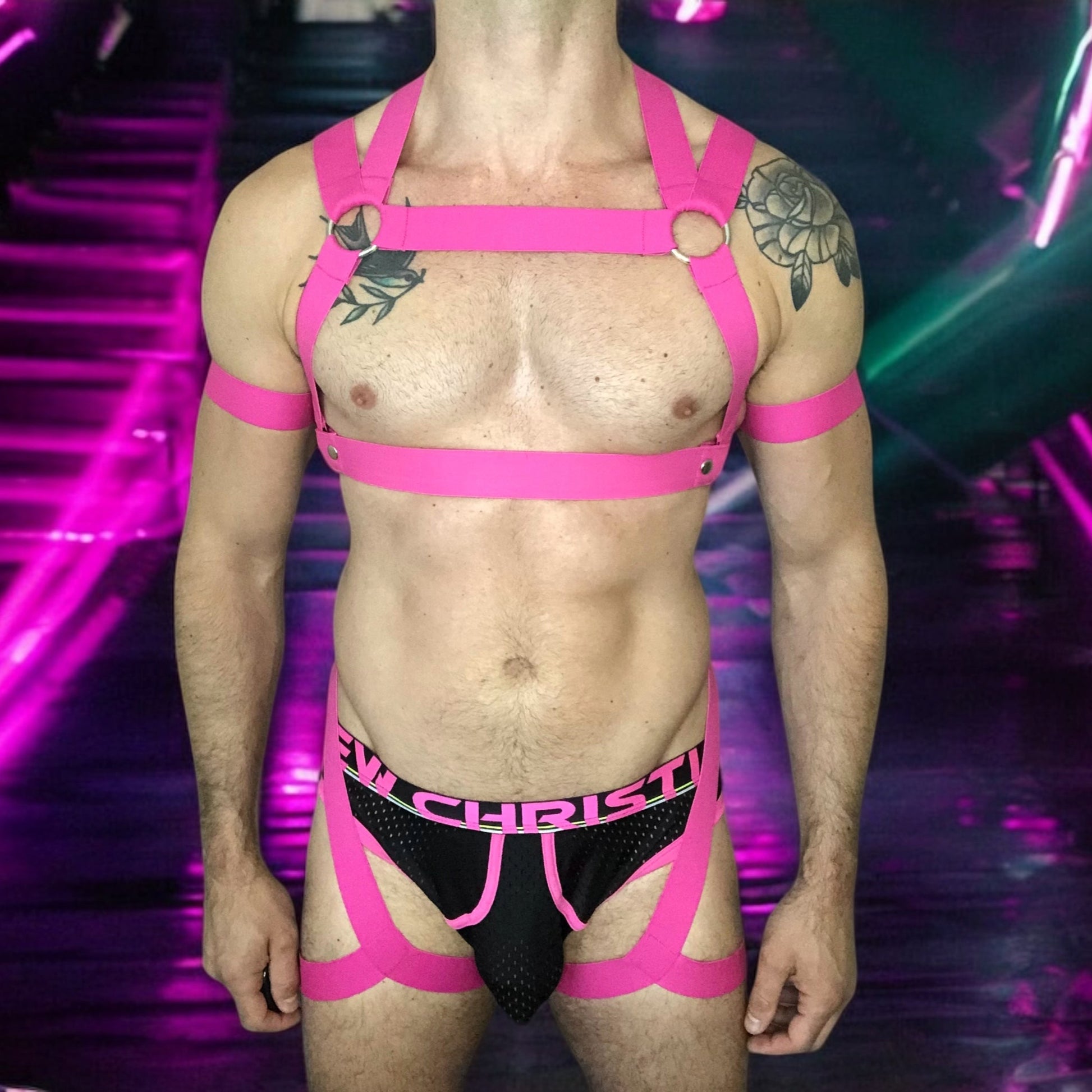 Man Wearing a Made-To-Measure Hot Pink Elastic Body Harness with Metal Rings and Matching Bicep Bands by Cheeky Boy Harness