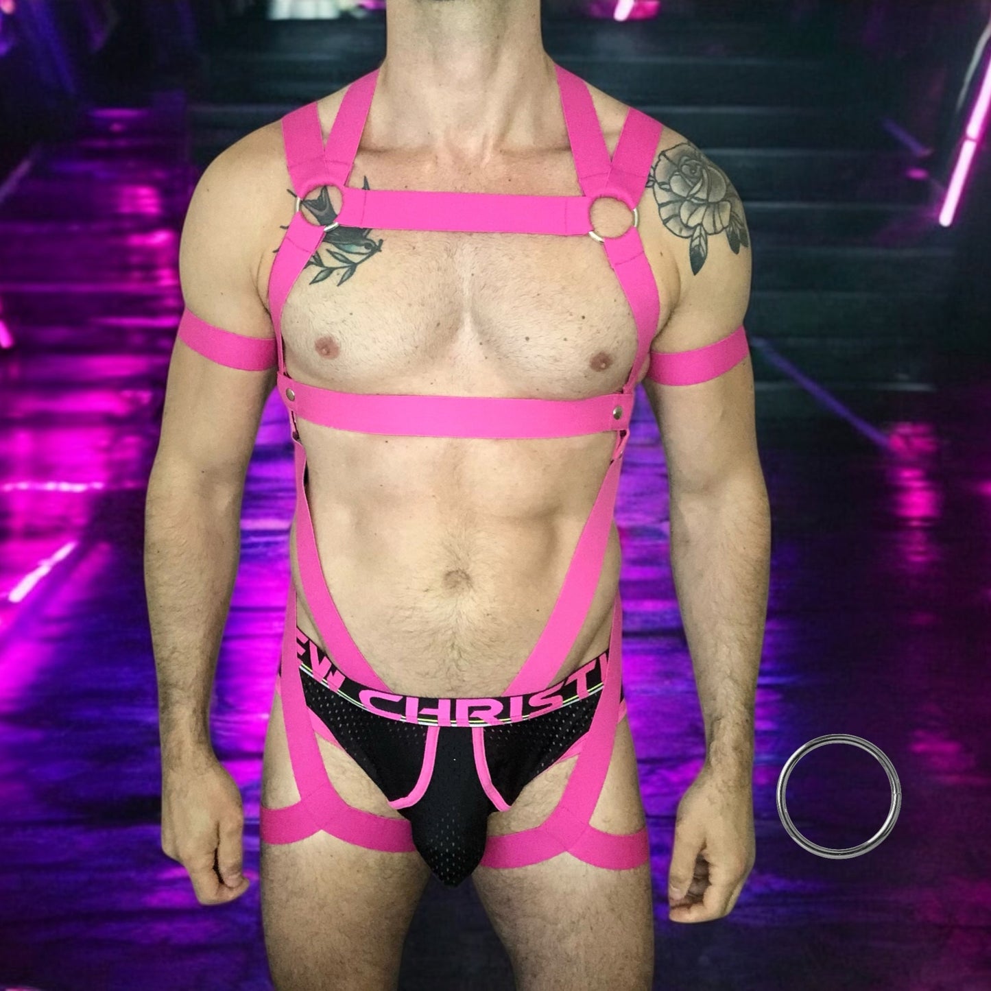 Man Wearing a Made-To-Measure Hot Pink Elastic Body Harness with Metal Rings and Matching Bicep Bands by Cheeky Boy Harness
