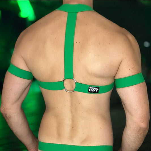 Model wearing a made-to-measure, full body harness in emerald green by Cheeky Boy Harness. The outfit features elasticated chest straps, matching thigh bands, and a black mesh jockstrap with a soft, stretchy pouch. Designed for a bold custom fit, this handmade set is ideal for Pride events, club nights, and fetish wear.