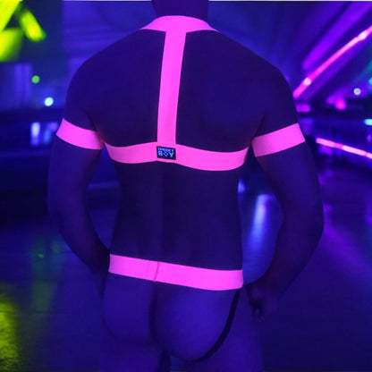 Model wearing a neon yellow chest harness with matching neon pink bicep bands and waistband jockstrap by Cheeky Boy Harness. Customisable colour options available. Perfect for festivals, clubwear, and pride events.