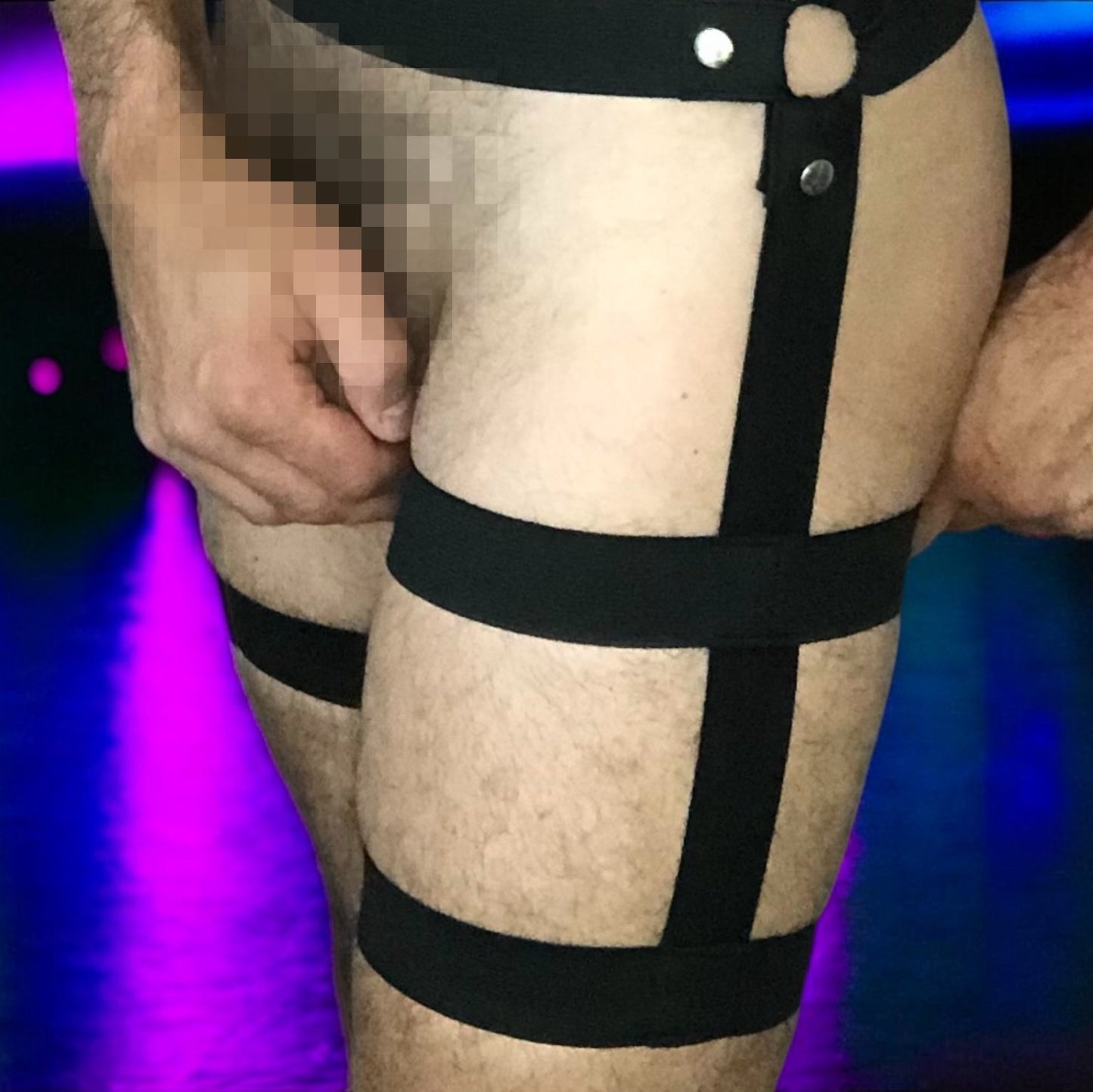 Male model wearing custom-made black elastic strap harness shorts by Cheeky Boy Harness, designed for fetishwear, clubwear, or festival fashion.